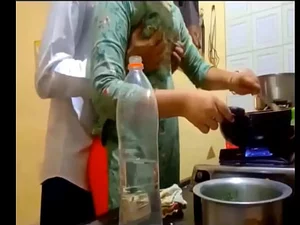 Indian aunty enjoys a steamy threesome with two men in the kitchen, leading to a unique experience.
