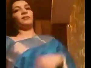 Irritated Indian aunty accidentally exposes herself in a public house move, leading to a steamy encounter.