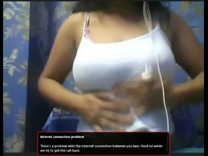Indian aunty's seductive webcam show in revealing clothes, authentic and captivating.
