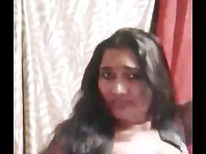 In this scorching Tamil video, an enticing aunty flaunts her seductive moves with a provocative striptease, leaving viewers craving for more.
